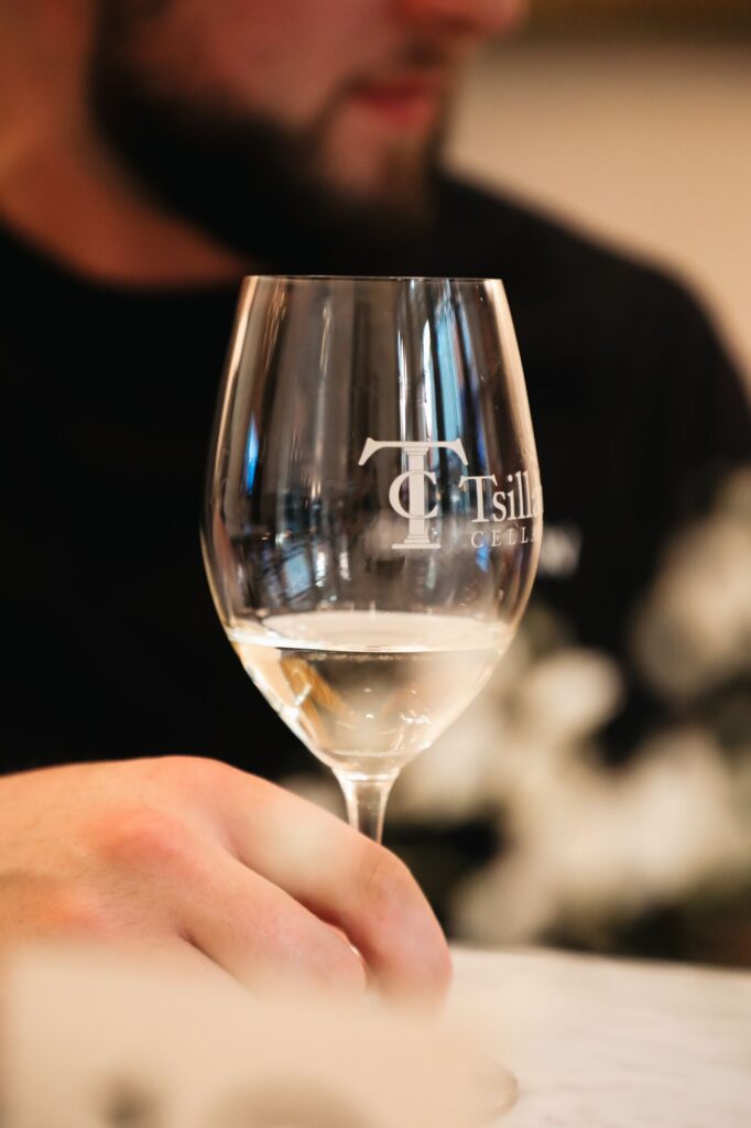 A wine glass etched with the Tsillan Cellars logo